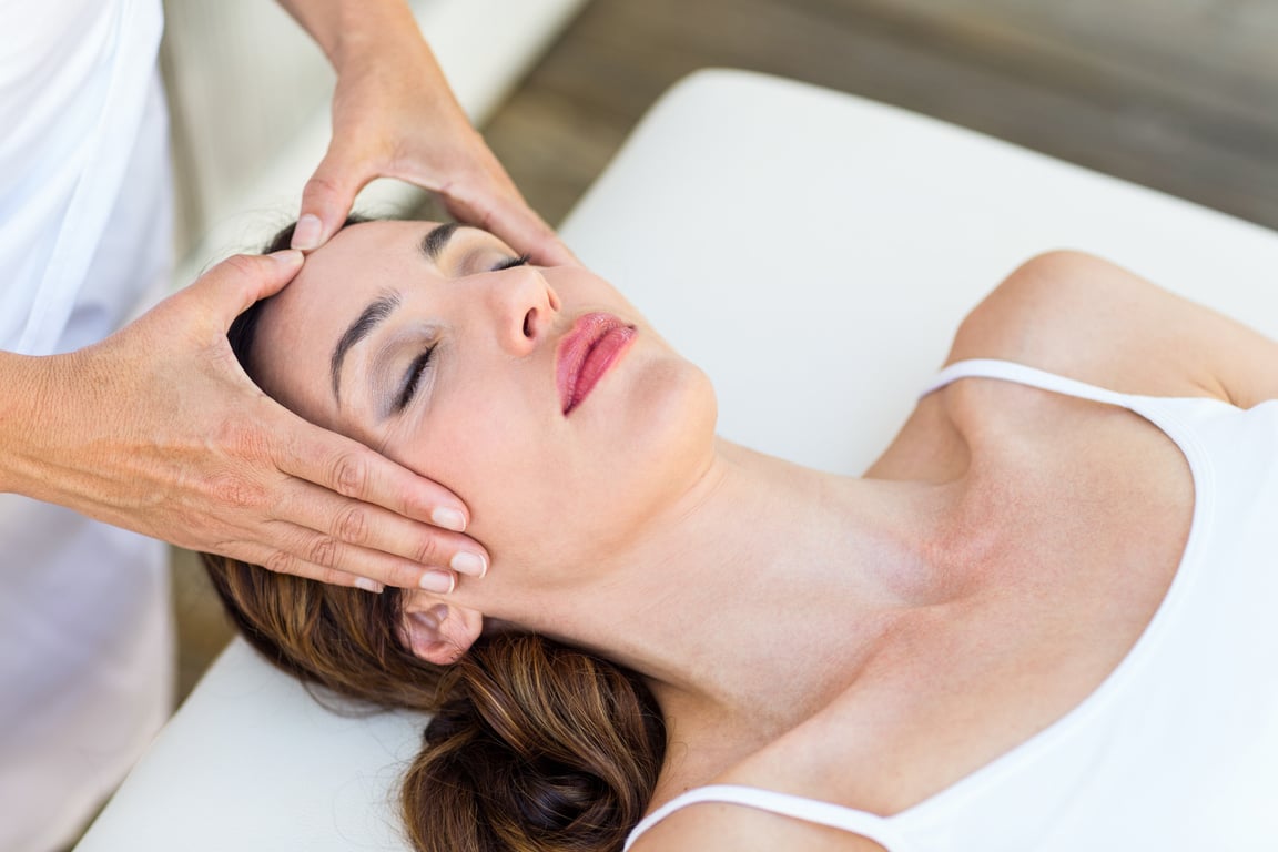 Calm woman receiving reiki treatment